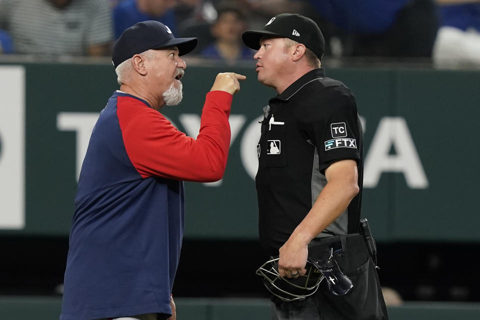 Atlanta Braves pitching coach Rick Kranitz, left, points and yells at umpire Cory Blaser during the second inning of a baseball game against the Texas Rangers in Arlington, Texas, Sunday, May 1, 2022. (AP Photo/LM Otero)