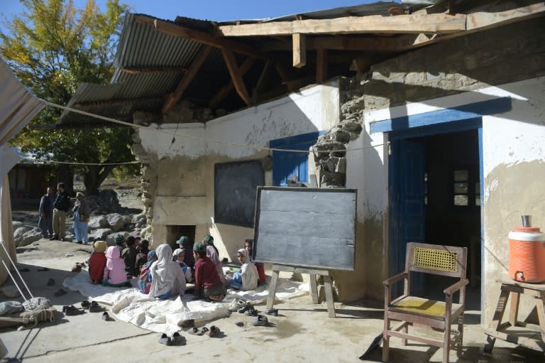 Pakistani children attend a class outside their earthquake-damaged school in Brun village, Bumburate valley