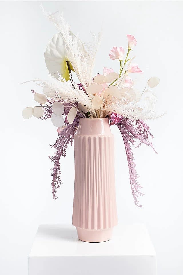 <p>If you're looking to truly impress, this phenomenal <span>Darby Creek Trading Sweet Escape Faux Pampas &amp; Sweet Pea Arrangement in Pink Vase</span> ($229) is something a loved one will cherish. The vase is so chic and can be used over again.</p>