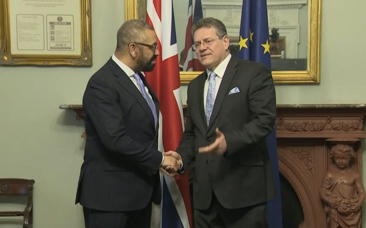 James Cleverly and Maros Sefcovic shake hands as the UK and the EU formally adopted the Windsor Framework Brexit deal - BBC