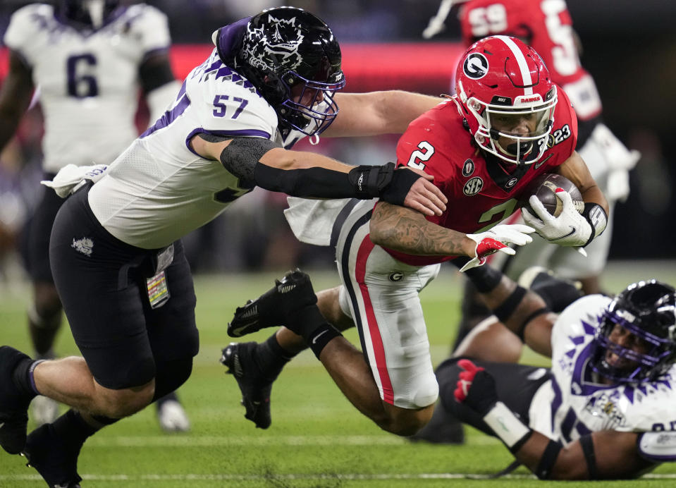 FILE - TCU linebacker Johnny Hodges (57) pressures Georgia running back Kendall Milton (2) during the first half of the national championship NCAA College Football Playoff game Jan. 9, 2023, in Inglewood, Calif. TCU opens their season against Colorado on Sept. 2. (AP Photo/Ashley Landis, File)