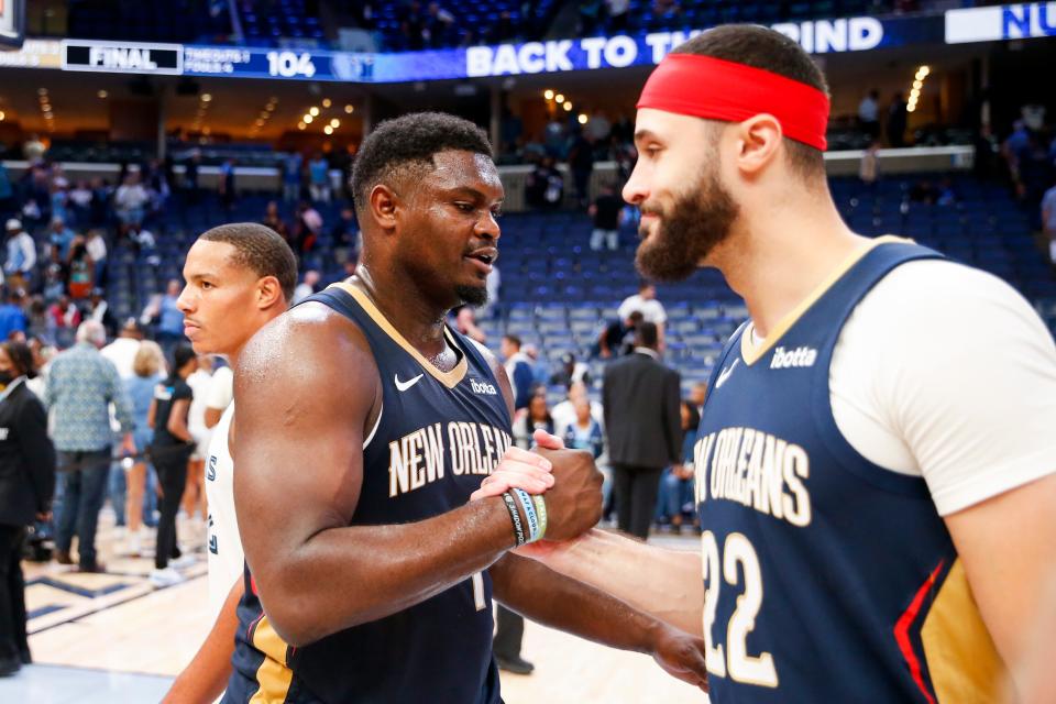 Pelicans' Zion Williamson (1) and Larry Nance Jr. (22) shake hands after defeating the Grizzlies 111-104 at FedExForum in Memphis, Tenn., on Wednesday, October 25, 2023.