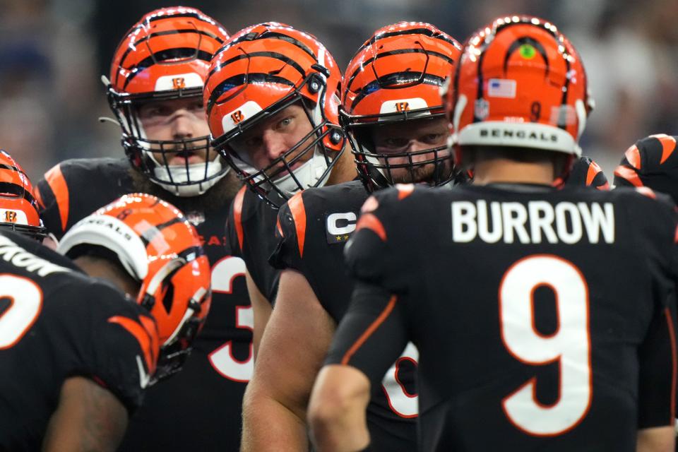 Cincinnati Bengals offensive tackle Jonah Williams (73), offensive tackle Cordell Volson (67) and center Ted Karras (64) listen to Cincinnati Bengals quarterback Joe Burrow (9) call a play in the third quarter of an NFL Week 2 game against the Dallas Cowboys, Sunday, Sept. 18, 2022, at AT&T Stadium in Arlington, Texas. The Dallas Cowboys won, 20-17.