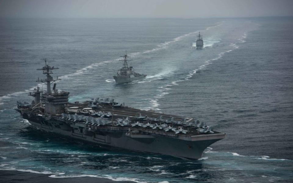 The aircraft carrier USS Theodore Roosevelt (CVN 71), front, the Arleigh Burke-class guided-missile destroyer USS Russell (DDG 59), center, and the Ticonderoga-class guided-missile cruiser USS Bunker Hill (CG 52) transit in formation.