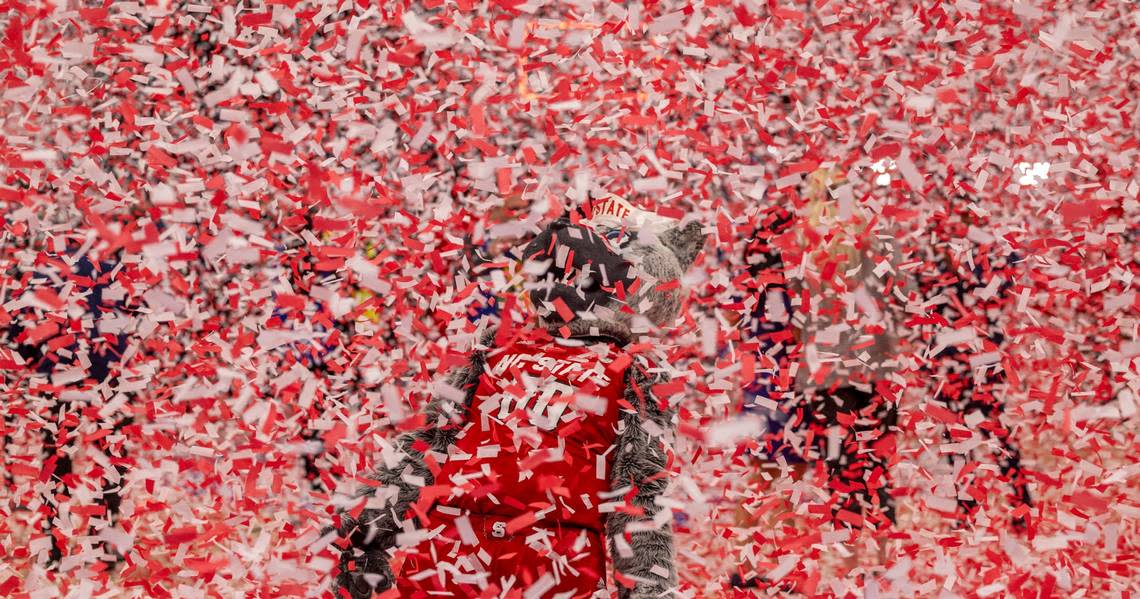 The N.C. State mascot Mr. Wolf is buried beneath a shower of confetti as they celebrate their 84-76 victory overt North Carolina to clinch the ACC Tournament Championship at Capitol One Arena on Saturday, March 16, 2024 in Washington, D.C.