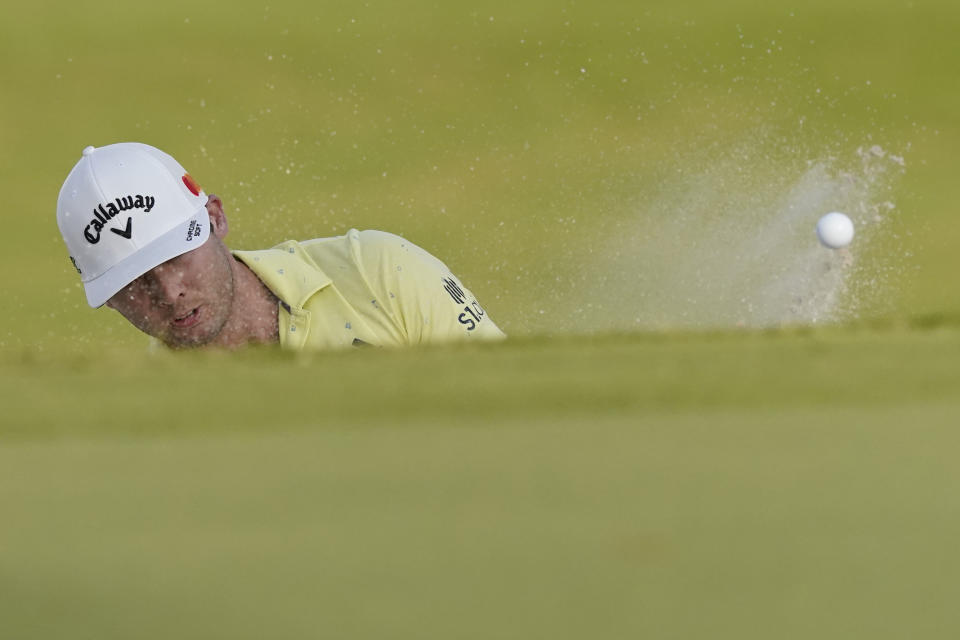 Sam Burns hits out of a sand bunker near the 18th hole during the final day of the Sanderson Farms Championship golf tournament in Jackson, Miss., Sunday, Oct. 3, 2021. (AP Photo/Rogelio V. Solis)