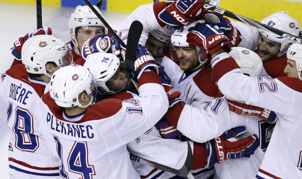 Montreal Canadiens defenseman P.K. Subban (76) is surrounded by teammates after scoring the game-winning goal off Boston Bruins goalie Tuukka Rask during the second overtime period of Game 1 in the second round of the Stanley Cup playoffs in Boston, Thursday, May 1, 2014. The Canadiens won 4-3. (AP Photo/Charles Krupa)