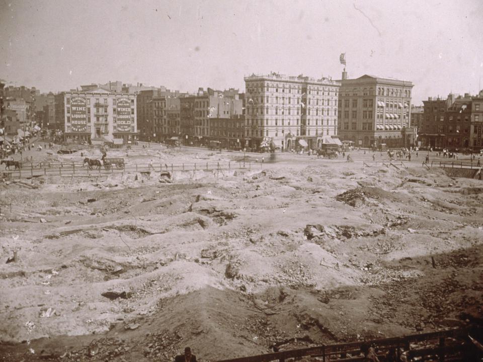 A barren plot of land where tenements once stood before being cleared for the construction of a park in New York City in 1898.