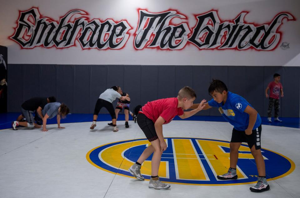 Casey Bittner, left, 10-year old wrestler from Salinas trains inside the Daniel Cormier Wrestling Academy in Gilroy, Calif., on Tuesday  Nov. 23, 2021. 