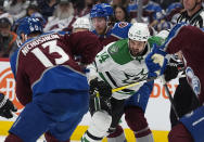 Dallas Stars left wing Jamie Benn, center, fights his way past Colorado Avalanche center Yakov Trenin, back, and right wing Valeri Nichushkin during the second period of Game 3 of an NHL hockey Stanley Cup playoff series Saturday, May 11, 2024, in Denver. (AP Photo/David Zalubowski)