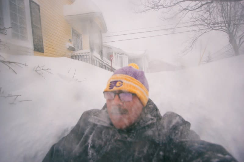 A man is pictured in a snowy street in St. John's, Newfoundland and Labrador