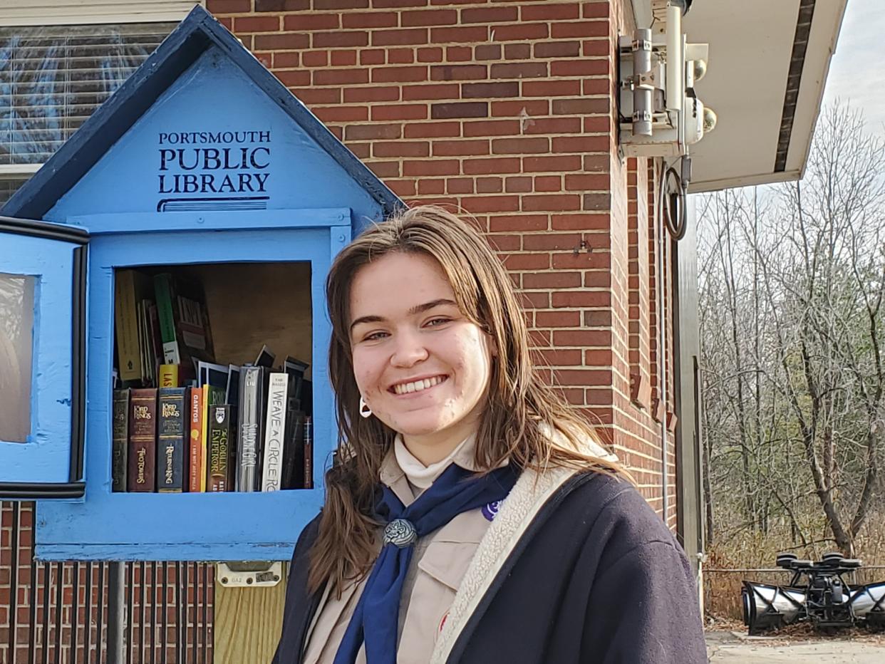 Lorely Godfrey of Troop 164G BSA stands in front of one of 11 Little Free Libraries she built as part of her Eagle Scout project. She will soon have the distinction of being the city's first female Eagle Scout.