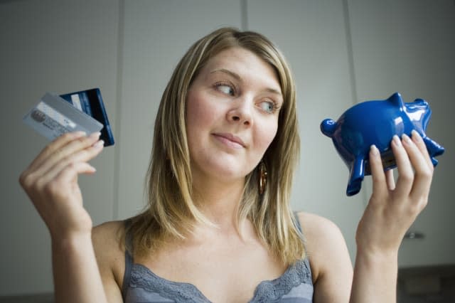 Girl with credit cards and piggy bank