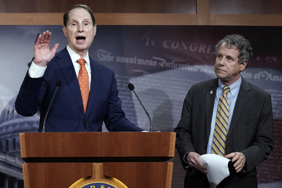 FILE - In this Wednesday, Jan. 15, 2020 file photo, Senate Finance Committee ranking member Ron Wyden, D-Ore., speaks during a news conference at the Capitol in Washington, about a U.S. China trade agreement, accompanied by Sen. Sherrod Brown, D-Ohio, right. On Friday, Sept. 25, 2020, Sens. Wyden and Brown said the government needs to ban the import of products made with child or forced labor after an Associated Press investigation found widespread exploitation in the palm oil industry, from debt bondage to outright slavery. (AP Photo/J. Scott Applewhite)