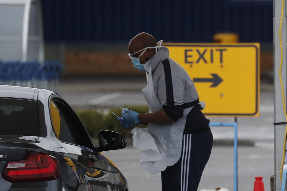 National Health Service staff wait in their cars to take a coronavirus test at a drive through centre in north London, Wednesday, April 1, 2020. The new coronavirus causes mild or moderate symptoms for most people, but for some, especially older adults and people with existing health problems, it can cause more severe illness or death.(AP Photo/Frank Augstein)