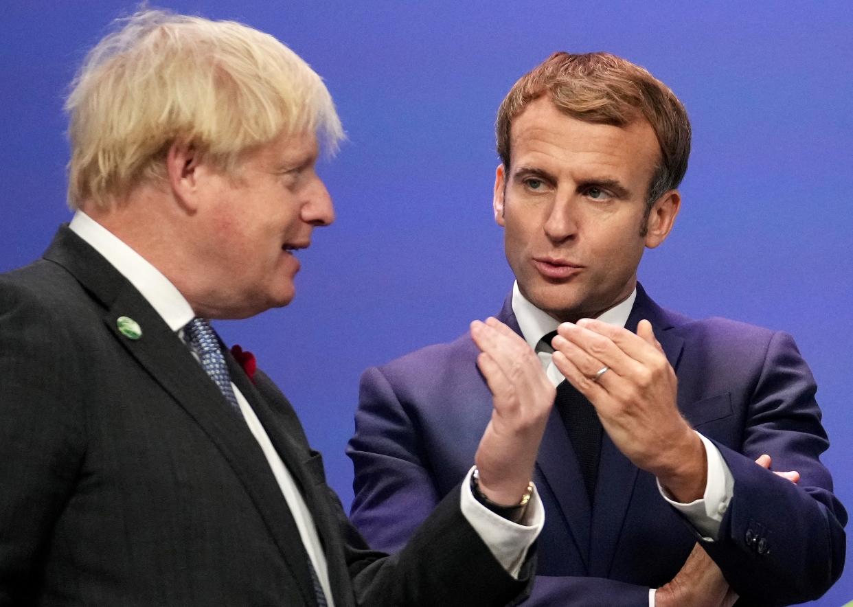 Britain's Prime Minister Boris Johnson greets French President Emmanuel Macron as he arrives to attend the COP26 UN Climate Change Conference in Glasgow, Scotland on November 1, 2021. - COP26, running from October 31 to November 12 in Glasgow will be the biggest climate conference since the 2015 Paris summit and is seen as crucial in setting worldwide emission targets to slow global warming, as well as firming up other key commitments. (Photo by Christopher Furlong / POOL / AFP) (Photo by CHRISTOPHER FURLONG/POOL/AFP via Getty Images)