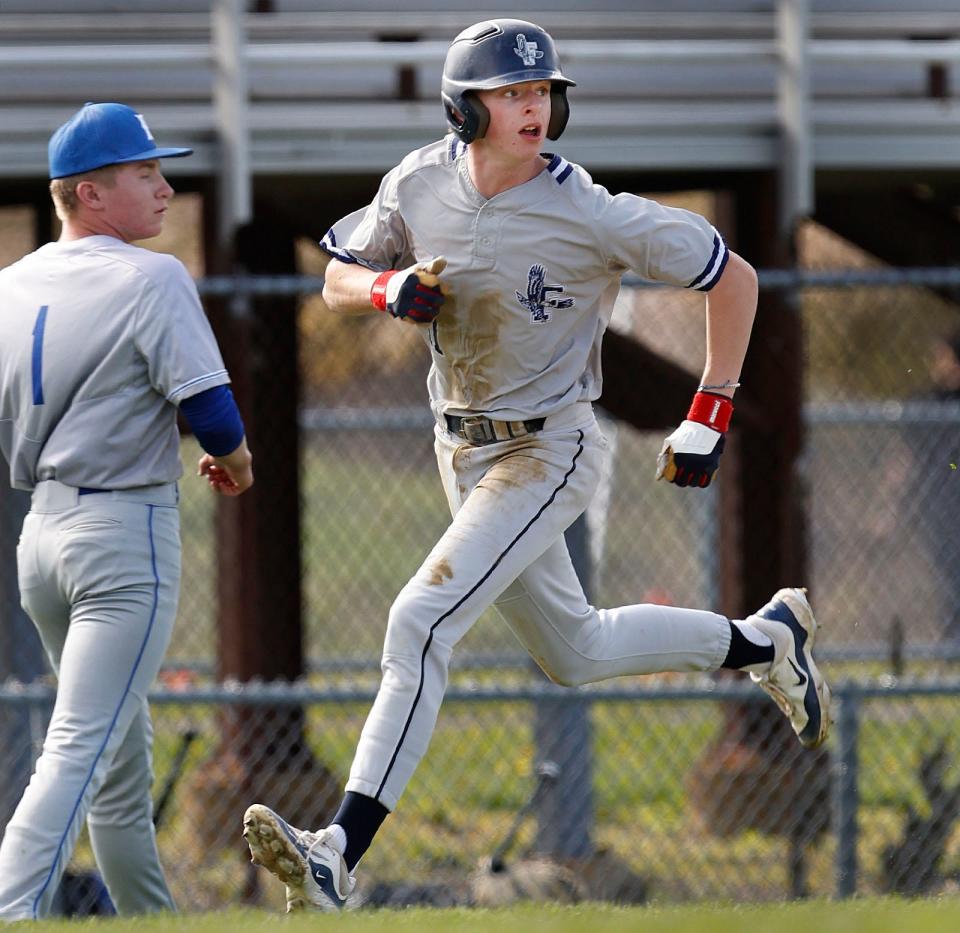 Flyers #11 Robby White looks to the outfield as he runs home past Braintree pitcher Max DeRoche to score.

The Braintree High Wamps hosted the Framingham Flyers in baseball on Wednesday May 1, 2024