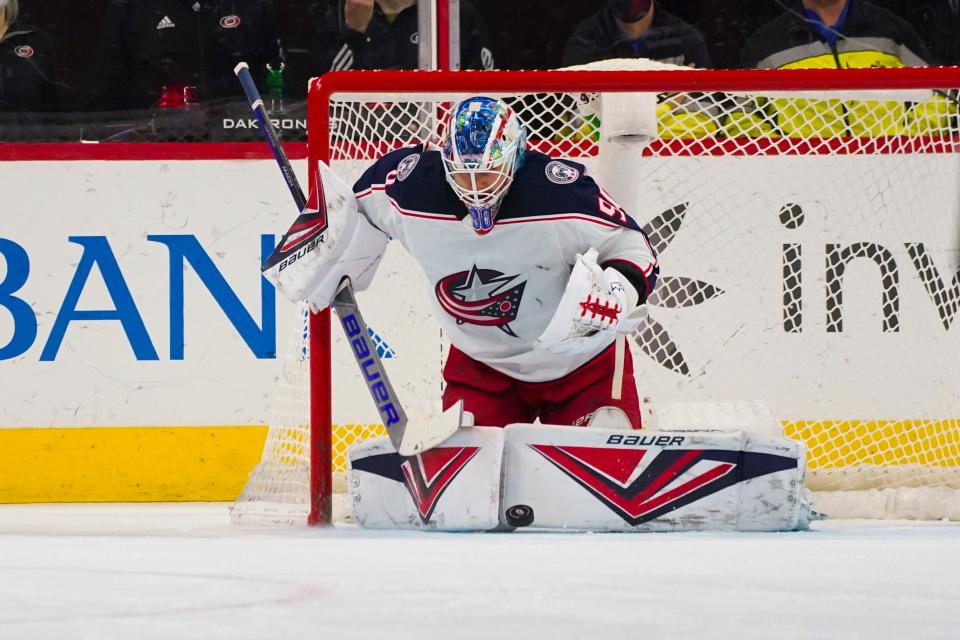 Jan 13, 2022; Raleigh, North Carolina, USA;  Columbus Blue Jackets goaltender Elvis Merzlikins (90) makes a save against the Carolina Hurricanes during the second period at PNC Arena. Mandatory Credit: James Guillory-USA TODAY Sports