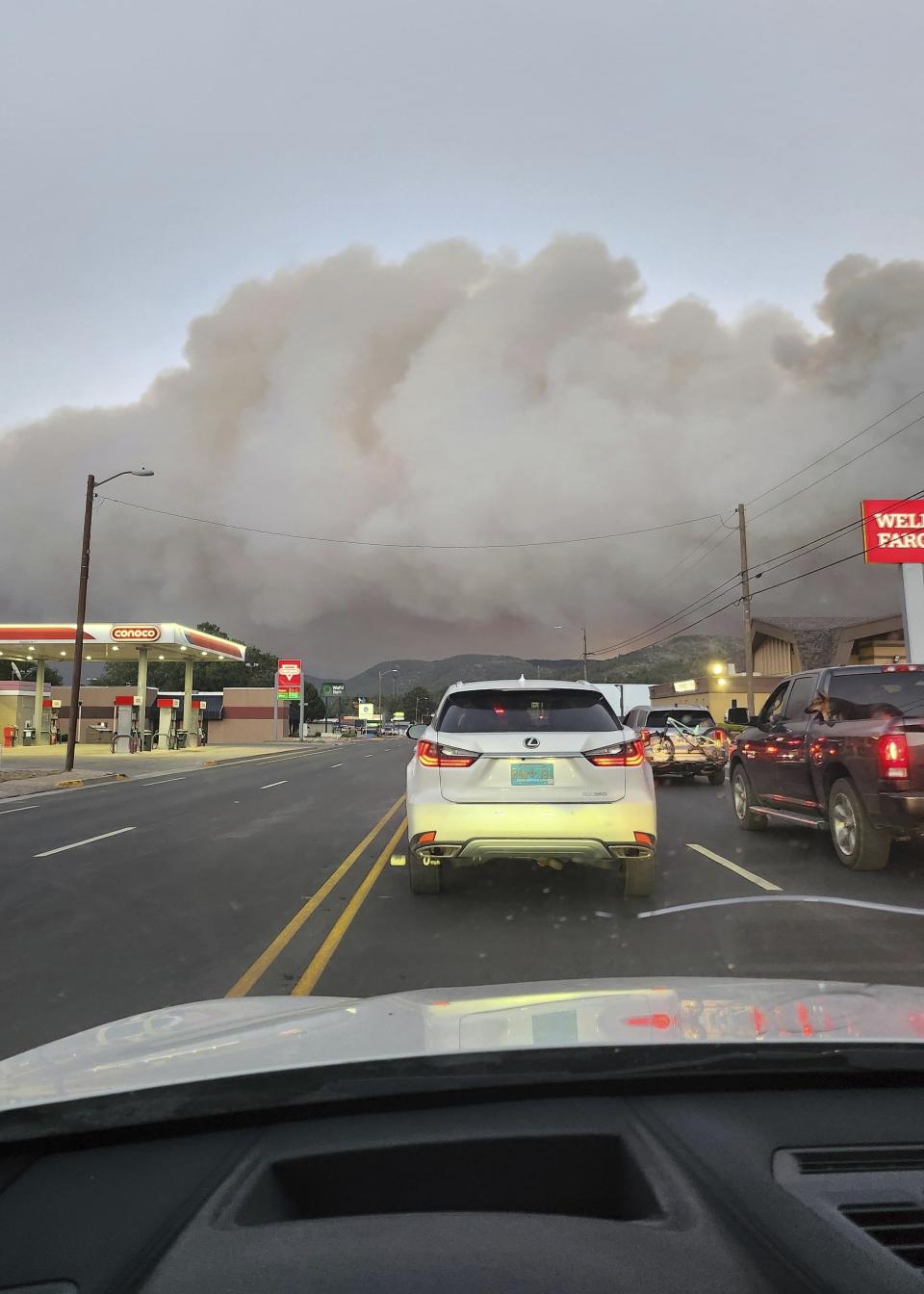 In this photo provided by Belinda Bukovitz, smoke rises from fires in Ruidoso, N.M., Monday, June 17, 2024. Thousands of southern New Mexico residents fled the mountainous village as a wind-whipped wildfire tore through homes and other buildings. (Belinda Bukovitz via AP)