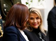 Bolivia's interim President Jeanine Anez talks with foreign minister Karen Longaric during a ceremony at the presidential palace in La Paz