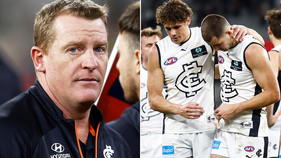 Carlton coach Michael Voss is pictured left, as players are seen walking off the ground on the right.