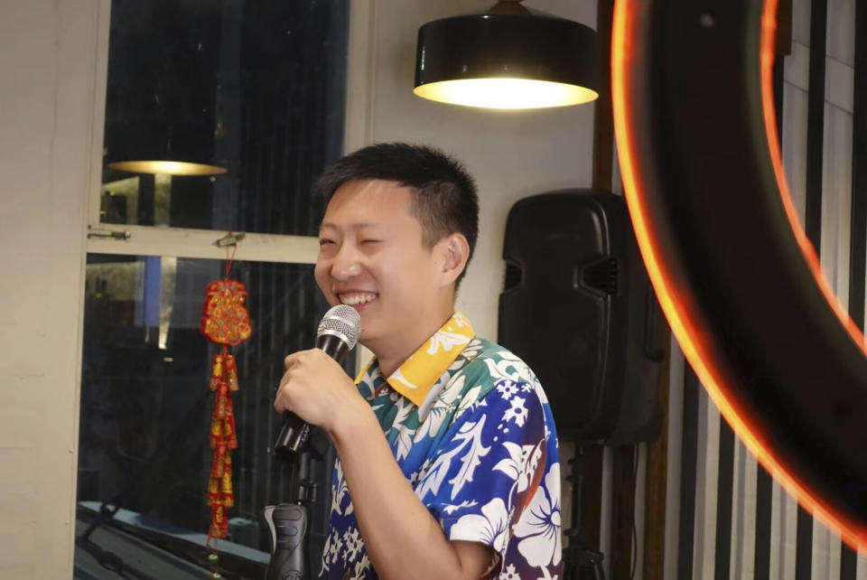 In this photo provided by Rena Gao, Xi Diao, a Chinese-born Australian civil engineer, performs standup comedy at a restaurant in Melbourne, Friday, March 25, 2022. (Rena Gao via AP）