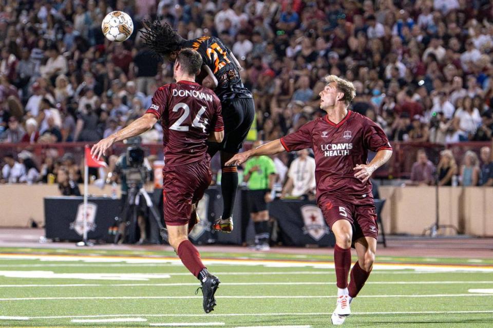 Orange County SC forward Thomas Amang (21) jumps for the ball during the first half of the USL soccer game at Hughes Stadium on Saturday. Republic FC returned to the site of its first match for a 10th-season celebration.