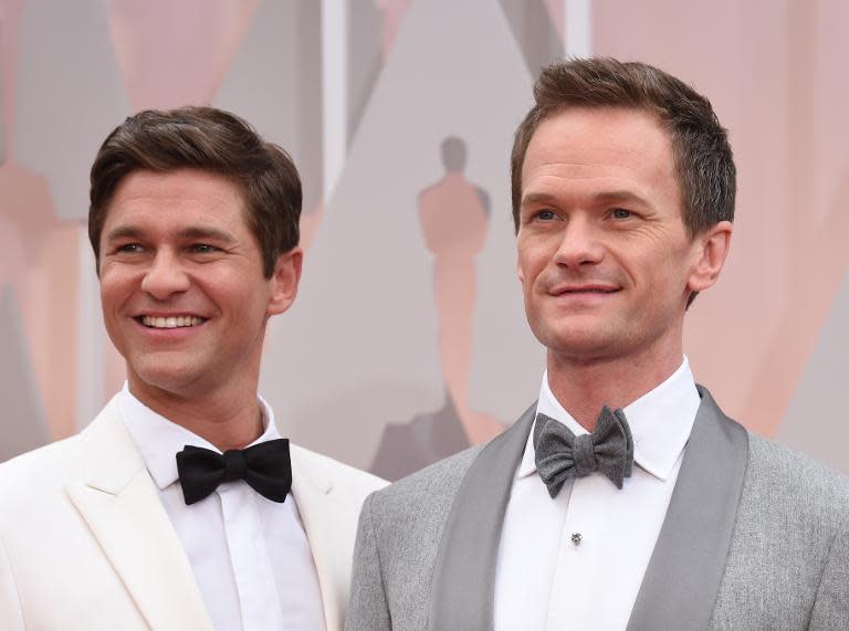 Host Neil Patrick Harris (R) and David Burtka arrive on the red carpet for the 87th Oscars February 22, 2015 in Hollywood, California