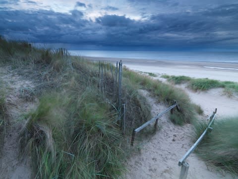 The beach and dunes here stretch for miles in both directions - Credit: GETTY