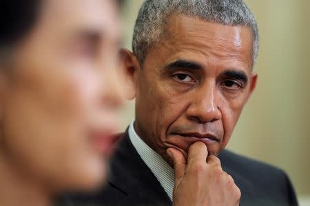 U.S. President Barack Obama listens as Myanmar's State Counsellor Aung San Suu Kyi talks to the media during a bilateral meeting at the Oval Office of the White House in Washington, D.C., U.S. September 14, 2016. REUTERS/Carlos Barria