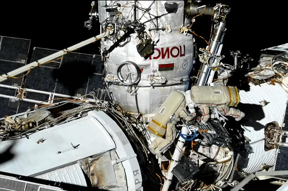 Russian cosmonauts Sergey Prokopyev (at right) and Dmitry Petelin work along a Strela boom during a Nov. 17, 2022 spacewalk outside of the Russian segment of the International Space Station.