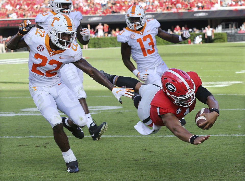 Georgia quarterback Justin Fields dives into the end zone past Tennessee defensive back Micah Abernathy for a 24-0 lead during the third quarter of an NCAA college football game Saturday, Sept. 29, 2018, in Athens, Ga. (Curtis Compton/Atlanta Journal Constitution via AP)