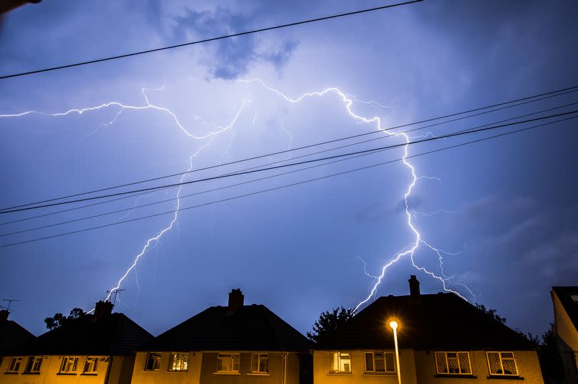 Thunderstorm with lightning over houses