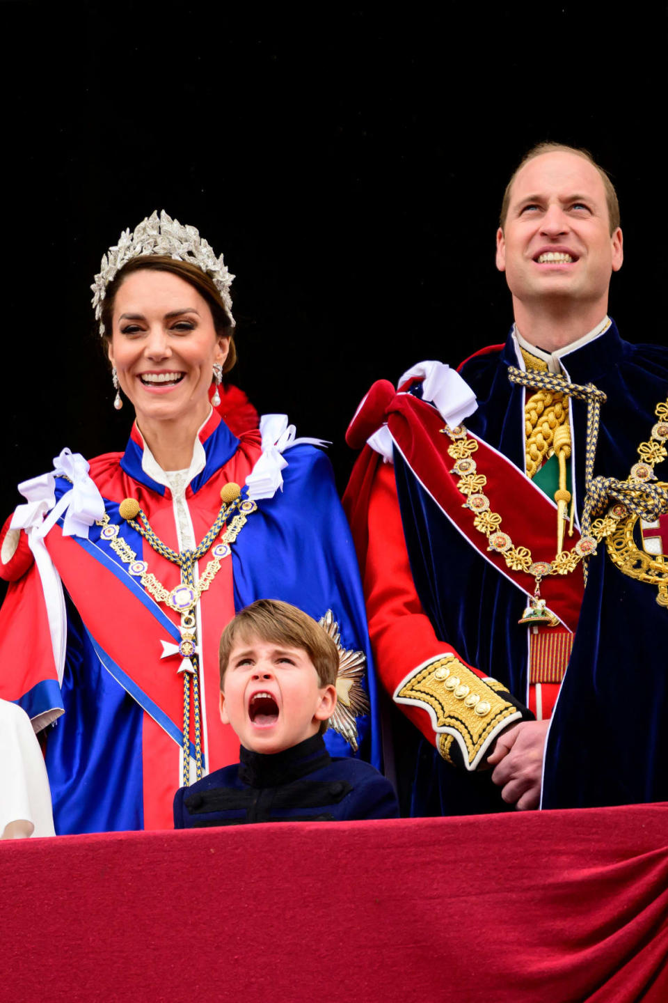 Kate, Duchess of Wales, Prince William of Wales, and Prince Louis stand on the balcony of Buckingham Palace during the coronation of King Charles III and Queen Camilla on May 6, 2023 in London, England.