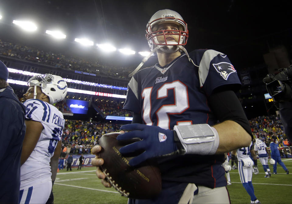 New England Patriots quarterback Tom Brady walks of the field with the football after an AFC divisional NFL playoff football game against the Indianapolis Colts in Foxborough, Mass., Saturday, Jan. 11, 2014. The Patriots defeated the Colts 43-22 to advance the AFC Championship game. (AP Photo/Matt Slocum)