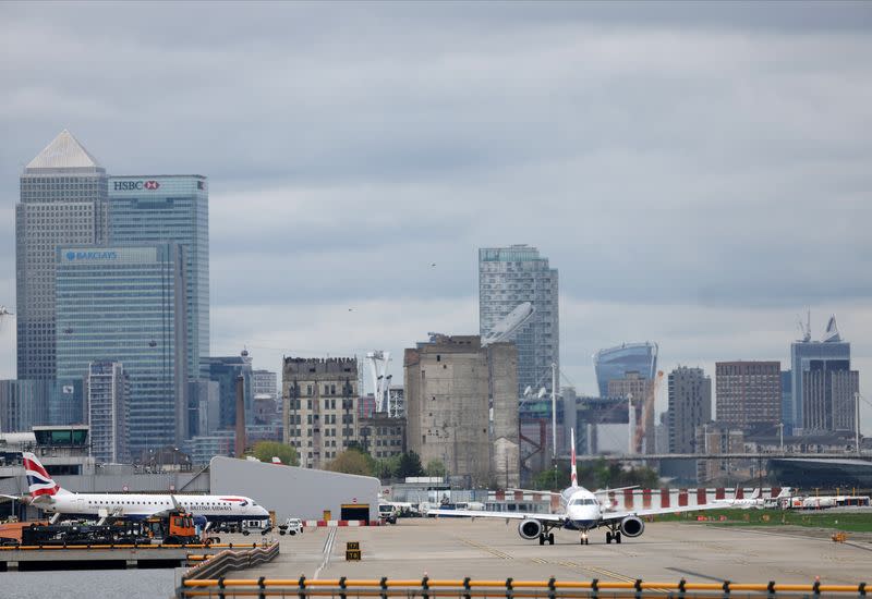 A British Airways Embraer ERJ-190SR passes as it takes off from London City Airport