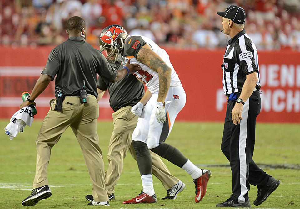 Sep 14, 2014; Tampa, FL, USA; Tampa Bay Buccaneers wide receiver Mike Evans (13) gets helped off the field after getting hit by St. Louis Rams defensive back T.J. McDonald (25) on the last play of the game at Raymond James Stadium. (Jonathan Dyer-USA TODAY Sports)