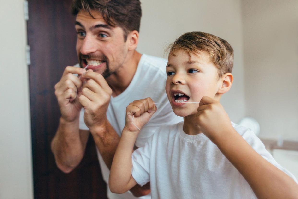 man and child flossing