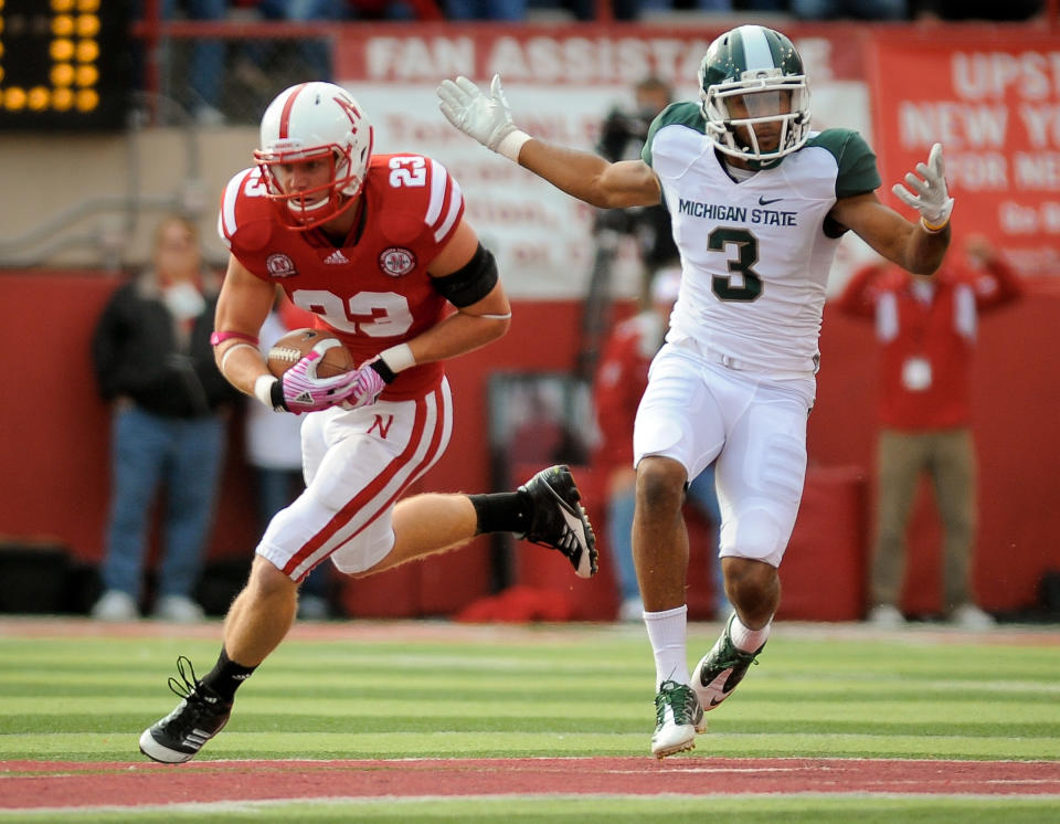 LINCOLN, NE - OCTOBER 29: Defensive back Lance Thorell #23 of the Nebraska Cornhuskers takes the ball away from wide receiver B.J. Cunningham #3 of the Michigan State Spartans during their game at Memorial Stadium October 29, 2011 in Lincoln, Nebraska. (Photo by Eric Francis/Getty Images)