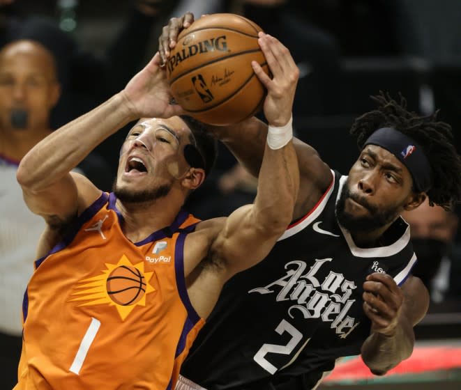 Thursday, June 24, 2021, Los Angeles CA - LA Clippers guard Patrick Beverley (21) fouls Phoenix Suns guard Devin Booker (1) late in the second quarter in Game three of the NBA Western Conference Finals at Staples Center. (Robert Gauthier/Los Angeles Times)