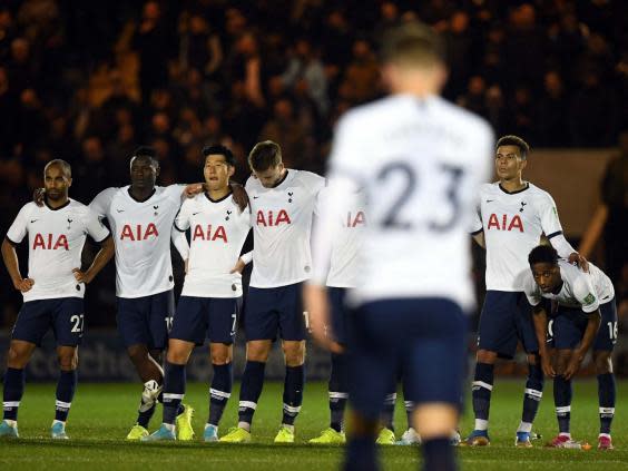 Tottenham players look on after Christian Eriksen's missed penalty (PA)