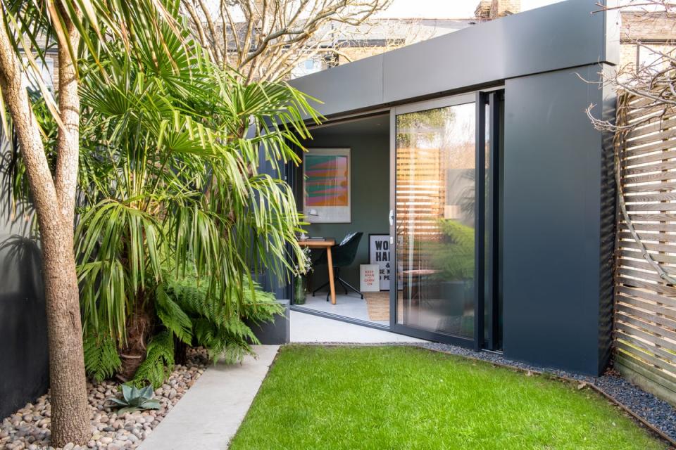 A triangular room was designed to fit a studio with a day bed, office space and shed (Joseph Traylen)