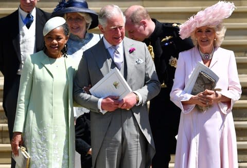 Doria Ragland, the Duchess of Sussex's mother, takes the arm of Prince Charles, outside St George's Chapel with his wife, the Duchess of Cornwall - Credit: Ben STANSALL/WPA/Getty