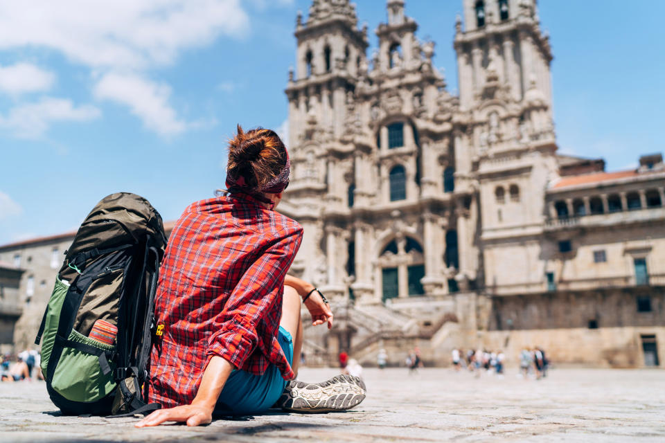 A backpacker admiring an old building