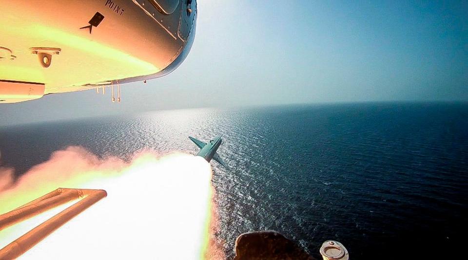 Iran's paramilitary Revolutionary Guard fired a missile from a helicopter targeting a replica aircraft carrier (AP)