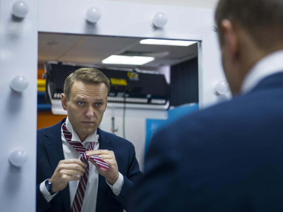 FILE - Russian opposition politician Alexei Navalny prepares himself prior his interview to the Associated Press in Moscow, Russia, Monday, Dec. 18, 2017. In a span of a decade, Navalny has gone from the Kremlin's biggest foe to Russia's most prominent political prisoner. Already serving two convictions that have landed him in prison for at least nine years, he faces a new trial that could keep him behind for another two decades. (AP Photo/Alexander Zemlianichenko, File)