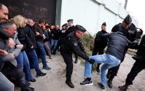 Riot police evacuate striking prison guards blocking the access to Borgo prison, Corsica - Credit: PASCAL POCHARD-CASABIANCA/AFP/Getty Images