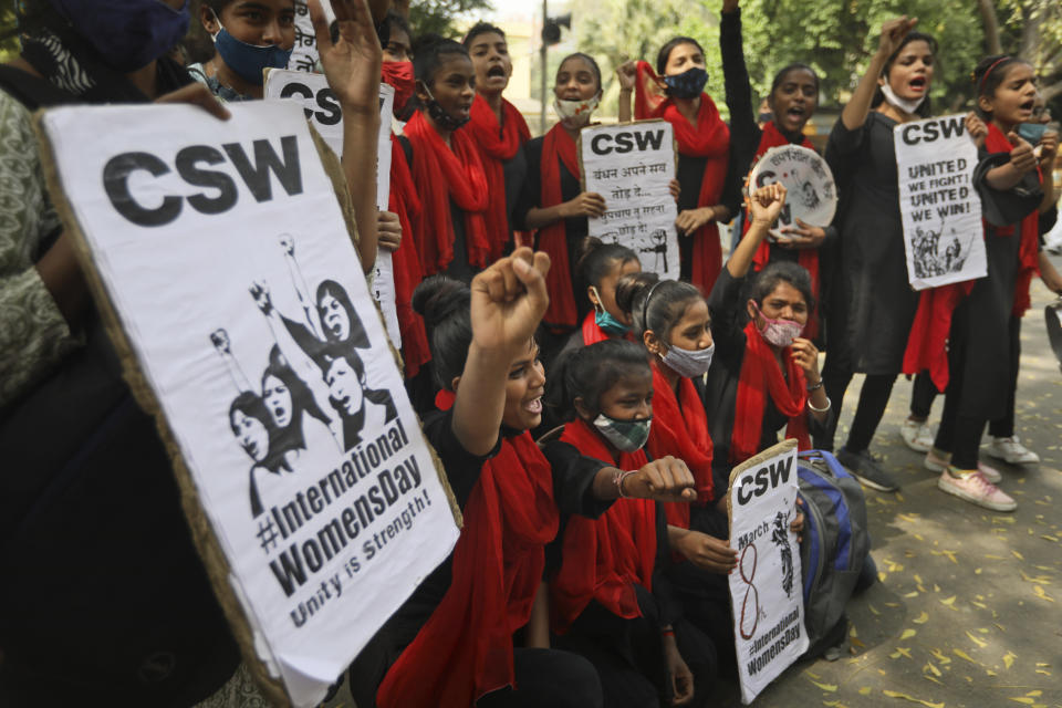 Members of different women's non governmental organizations shout slogans to mark International Women's Day in New Delhi, India, Monday, March 8, 2021. Thousands of female farmers have held sit-ins and a hunger strike in India's capital in protests on International Women's Day against new agricultural laws. (AP Photo/Manish Swarup)