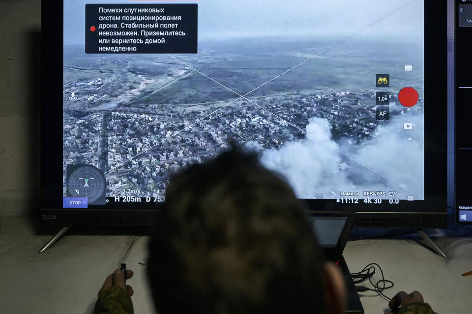 A Ukrainian soldier watches a drone feed from an underground command center in Bakhmut, Donetsk region, Ukraine, Sunday, Dec. 25, 2022. (AP Photo/Libkos)