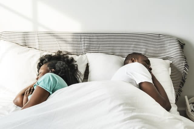 African descent couple sleeping on the bed